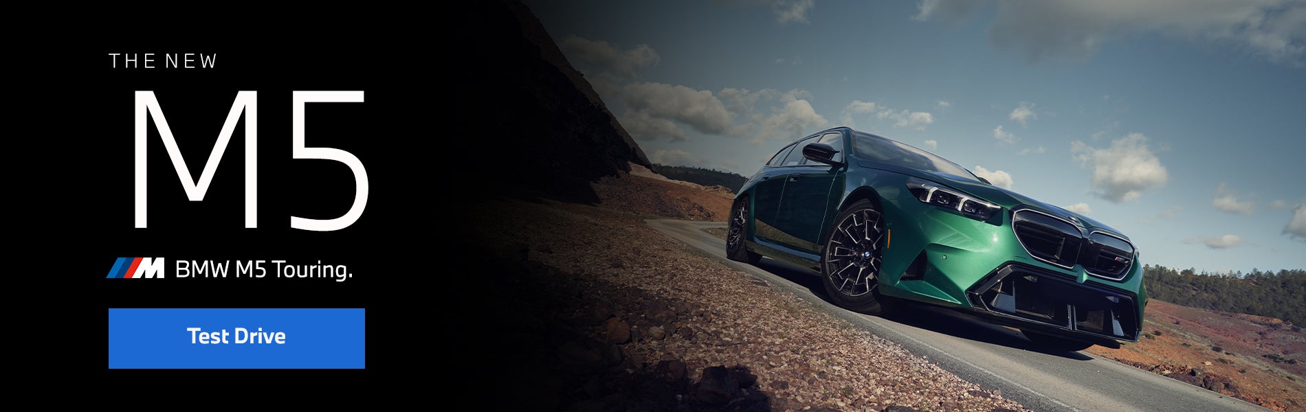 The new BMW M5 Touring in green driving down desert road | Ferman BMW in Palm Harbor FL