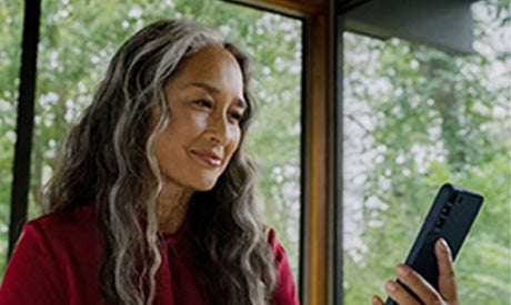 Image of a woman looking at her phone.