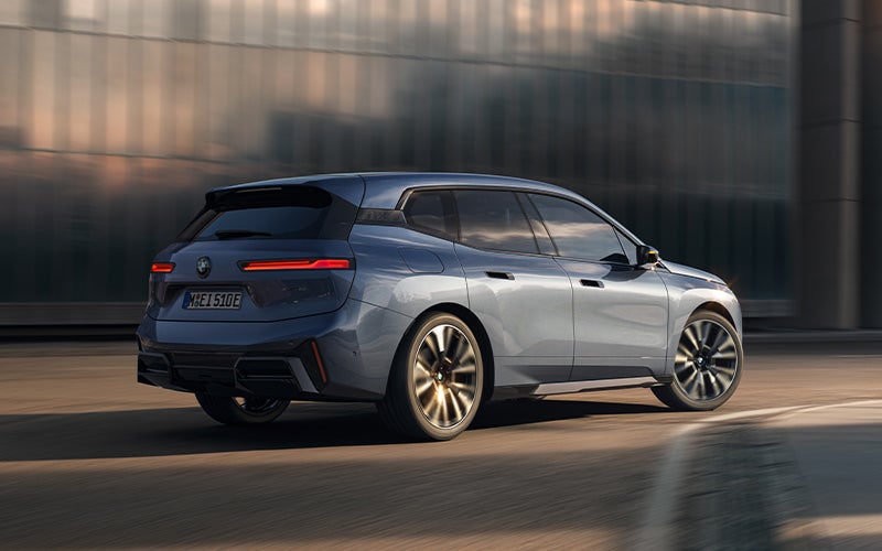 The BMW iX driving with the front wheel turned. | Ferman BMW in Palm Harbor FL